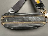 a black purse with a gold zipper on it