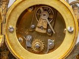 a close up of a gold clock with gears on it
