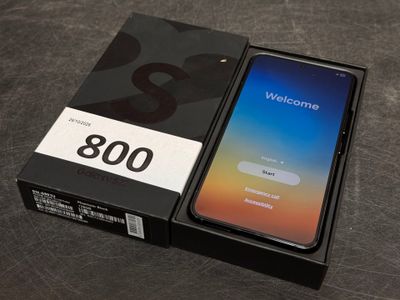an open box with a phone inside of it on a table