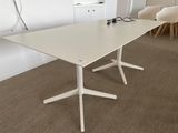 a white table with two chairs in the corner of the room