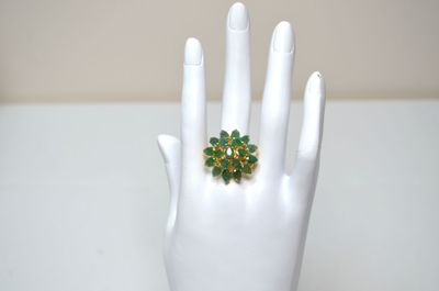 an image of a hand with a ring on it ' s finger