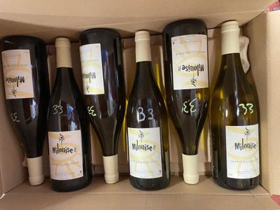 six bottles of wine in a box with labels on them