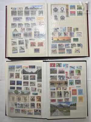 two open books with stamps on them sitting on a table