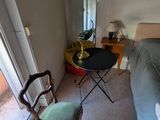 une pièce avec un lit, une chaise, une table et un miroir
