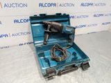an electric drill in a blue case on a white surface