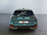 the rear view of a green car in a showroom