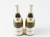 two bottles of wine sitting next to each other on a white surface