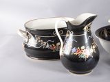 a black and white pitcher and a bowl on a table