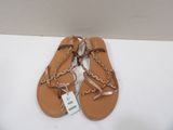 a pair of sandals with a tag on them sitting on a white surface