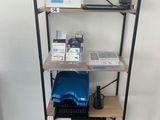a shelf that has a laptop and other items on it