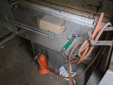 a machine that is sitting in a room with a lot of tools