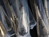 a lot of spoons that are wrapped in plastic bags