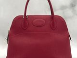 a red leather handbag on a white background