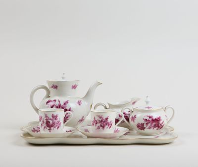 an image of a tea set on a tray on a white surface