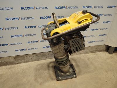 a close up of a machine on a stand in front of a wall