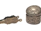 a small silver box and a small silver object