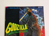a sticker of a godzilla monster on a refrigerator