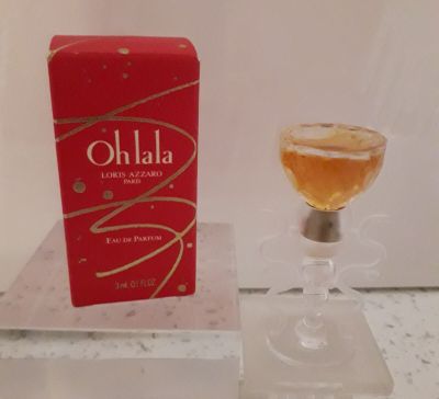 un verre de vin posé sur une table à côté d'une boîte rouge