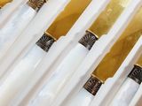 a lot of gold and white knives on a white table