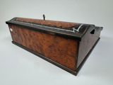 an old wooden box sitting on top of a white surface