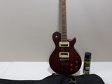 a guitar that is sitting on a table next to a guitar case