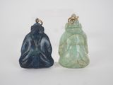 two jade buddha figurines, one blue and one green