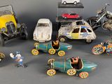 a lot of toy cars and motorcycles that are on a table