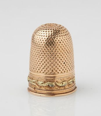 an 18k gold thimble with a design on it