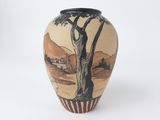 a vase that has a picture of a tree on it