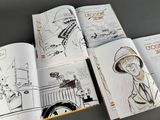 a bunch of books that are open on a table