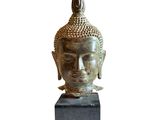 an image of a statue of a buddha head on a block