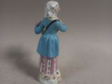 a figurine of a woman with a cat on a leash
