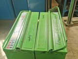 two green boxes sitting on top of a workbench