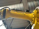 a yellow robot that is attached to a wall