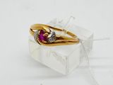 a gold ring with a ruby and diamond on it