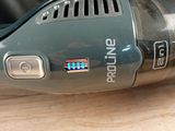 someone is using a cordless vacuum cleaner on a wooden table