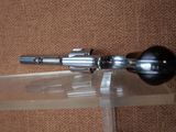 a gun that is sitting on top of a glass table