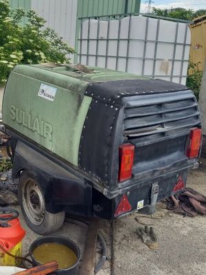 a truck that is parked next to a pile of trash