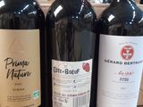 three bottles of wine sitting on top of a counter next to each other