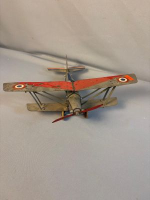 a toy airplane that is sitting on a white surface