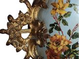 a vase with flowers painted on it sitting on a table