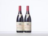 two bottles of red wine sitting next to each other on a table