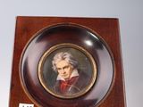 portrait of a man in a red coat in a wooden frame