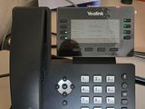 a telephone that is sitting on a desk next to a calendar