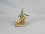 figurine of a man playing a flute on a white background