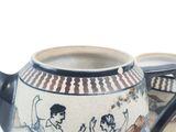 a close up of a tea pot with a painting on it