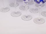 several wine glasses are lined up on a white table