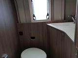 a toilet in the corner of a small bathroom