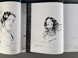 an open book with a drawing of a woman and a man on it
