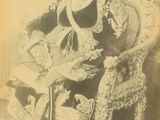 an old photo of a man sitting in a chair with a hat on